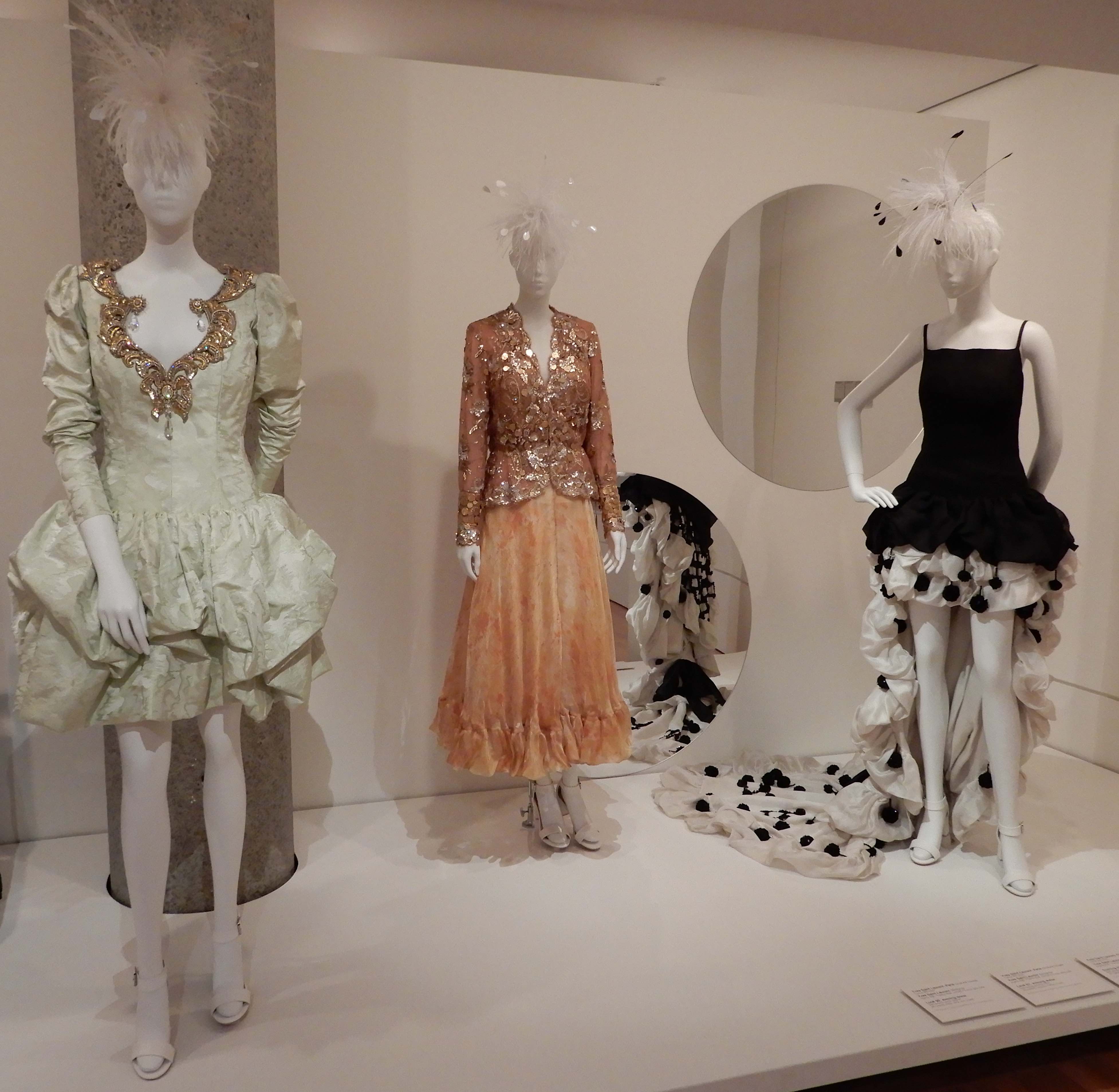 71.(L-R)Yves Saint Laurent, Look 96 evening dress 1990; Look 67 evening dress 2000; evening dress 1990